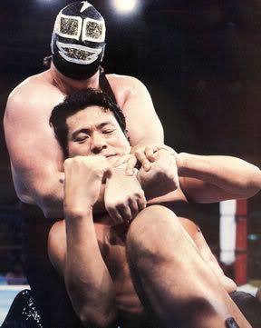 Super Machine has Antonio Inoki in a chinlock in NJPW