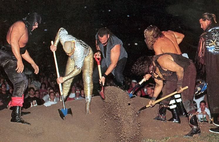 Mankind burying The Undertaker Pictures, Images and Photos
